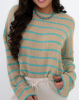 Close-up of Coastal Spring Stripe Sweater featuring breathable mocha and aqua striped knit fabric and relaxed fit for casual spring layering.