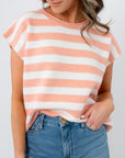 Rosie Peach Stripe Sleeveless Sweater Vest in blush and white stripes, styled with light denim jeans. Lightweight knit ideal for spring layering.