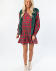 Boutique holiday look featuring Frosted Pine Green Faux Fur Vest paired with a plaid dress and ankle boots, ideal for winter parties.