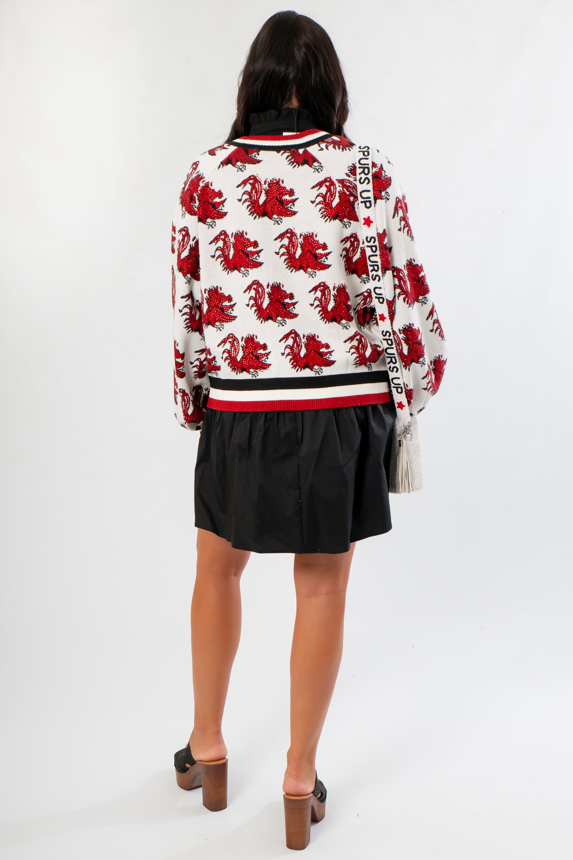 Back view of Queen of Sparkles USC Gamecocks Mascot Rhinestone Cardigan with all-over red Gamecock design and varsity-style striped hem.
