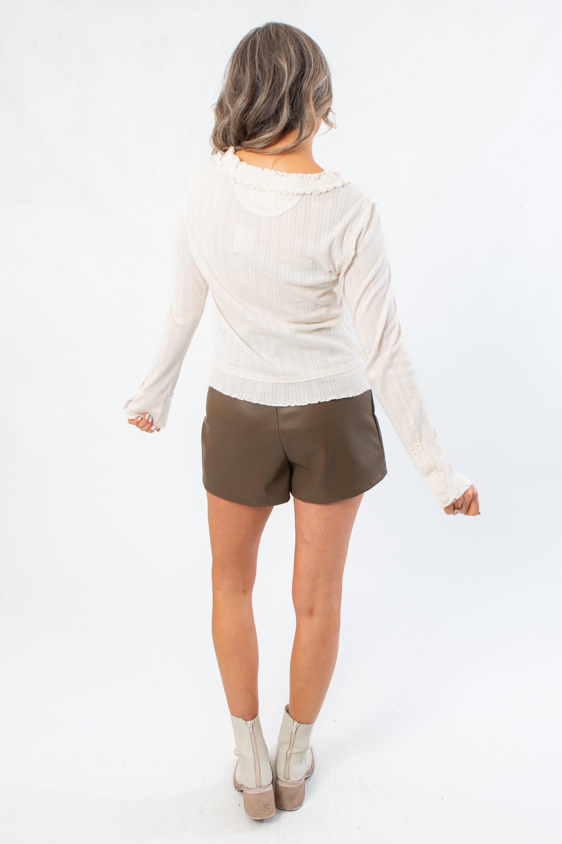 Back view of Free People Through the Woods Tee - A Frame Combo We The Free Knit Top with subtle ruffle hem and soft ribbed fabric.