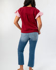 Back view of Red Burgundy Knit Top with cable knit pattern and ruffle sleeve detail, offering a cozy and stylish wardrobe upgrade.