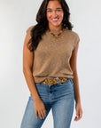 Tiffany Sleeveless Brown Ribbed Knit Top with crew neckline and relaxed fit, styled with jeans for a cozy fall look.