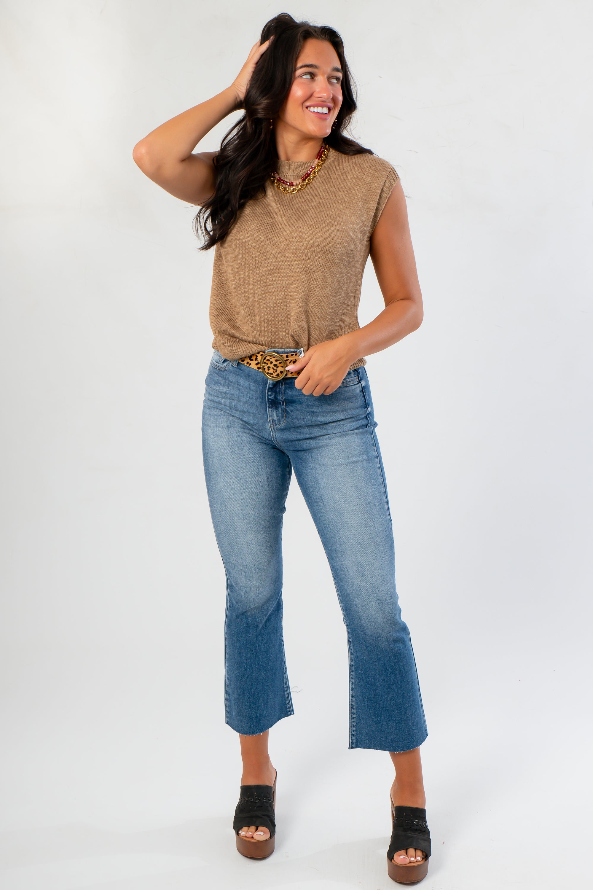 Cozy fall essential Tiffany Sleeveless Brown Ribbed Knit Top paired with cropped jeans and leopard belt for a casual autumn outfit.