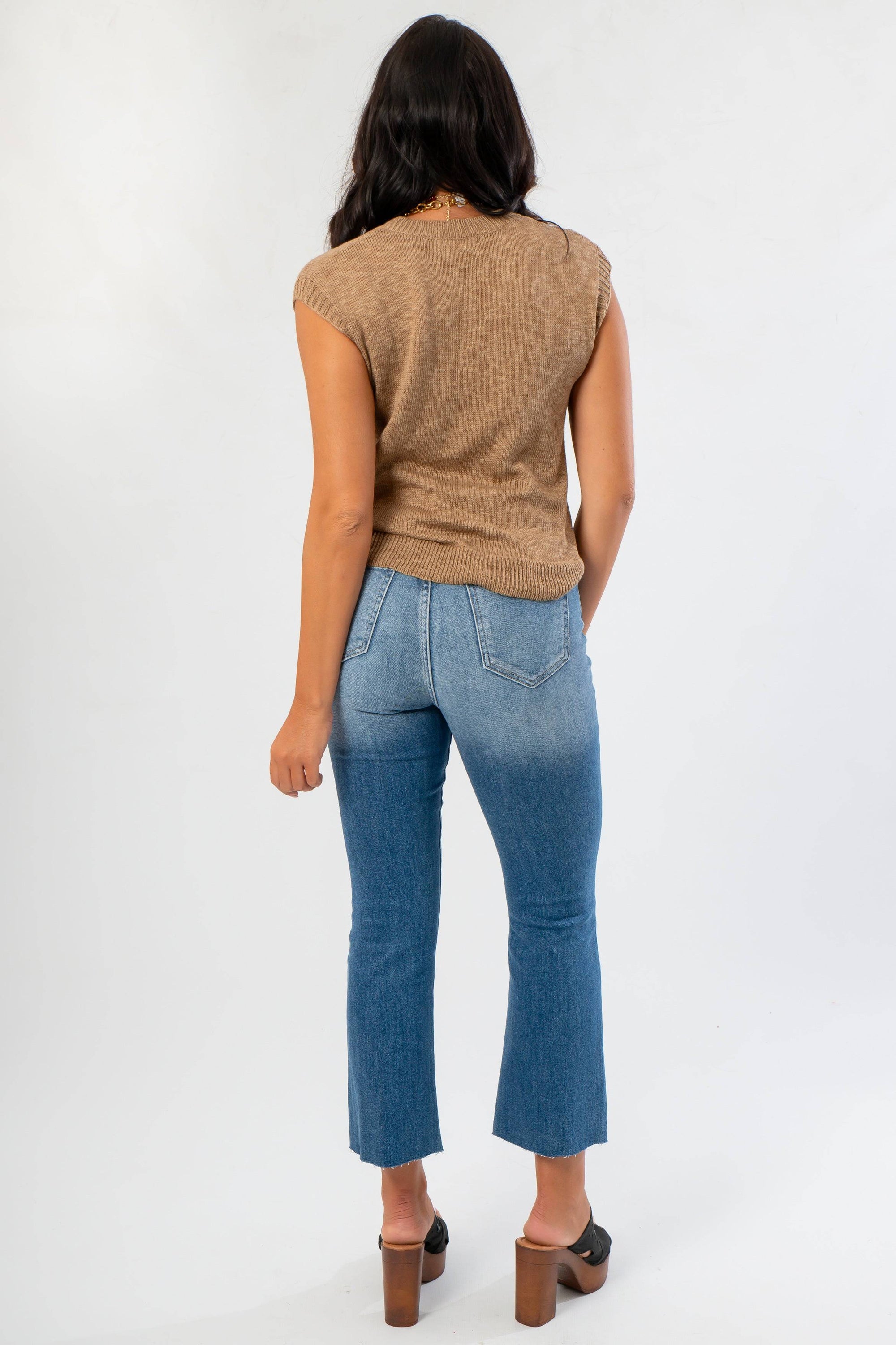 Back view of Tiffany Sleeveless Brown Ribbed Knit Top highlighting ribbed hem and soft knit fabric, perfect for warm autumn days.