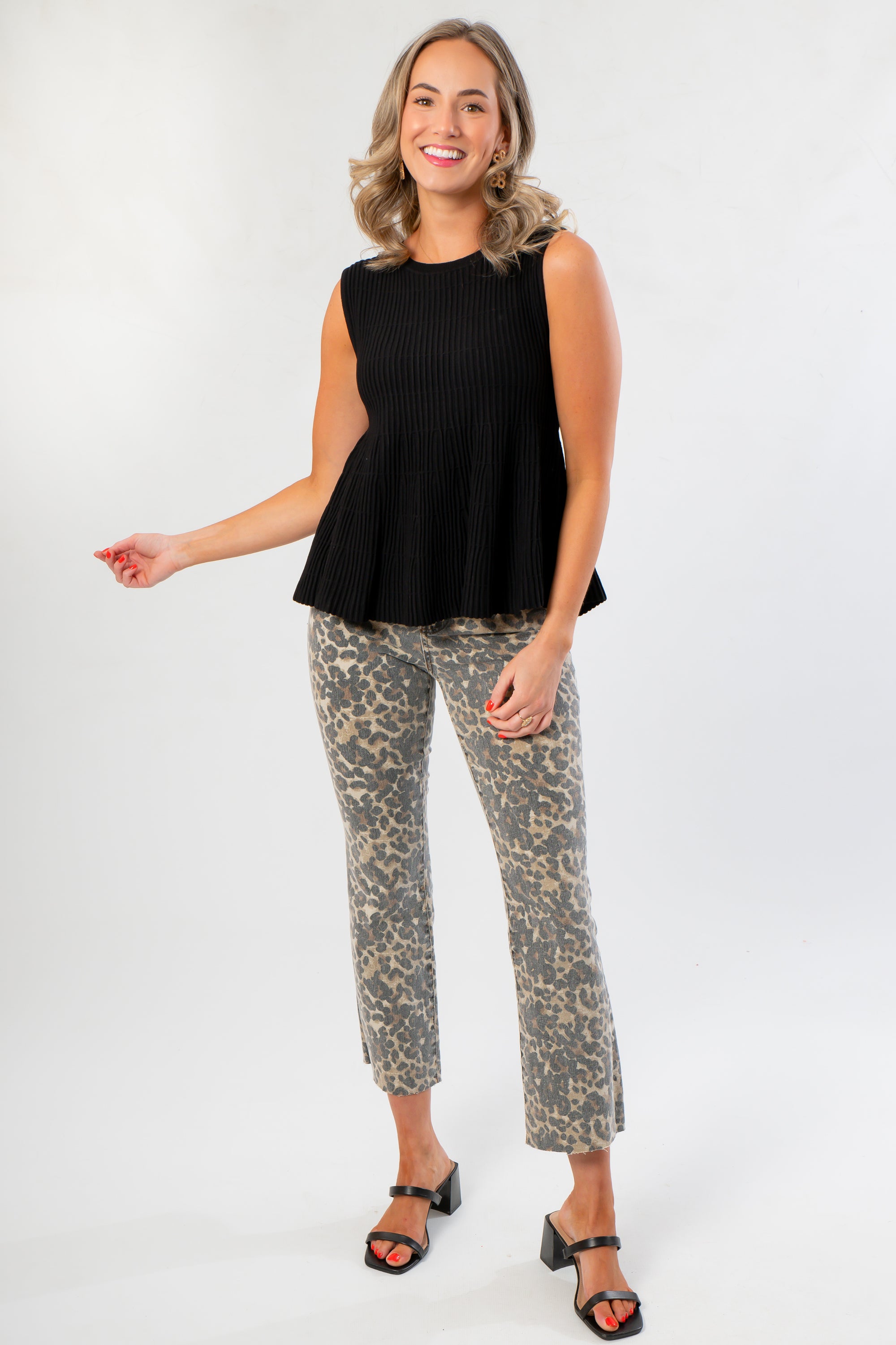 Black Flared Rib Knit Top – Stylish & Comfortable Knitwear featuring a sleeveless design and flared hem, paired with leopard print pants.
