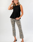 Sleeveless Black Flared Rib Knit Top with a textured ribbed pattern and peplum silhouette, styled for a chic and versatile look.