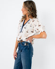 THML Sailboat Short Sleeve Blouse styled with denim and belt, showcasing its casual chic summer appeal.