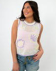 Gia Crochet Shell Knit Tank in white with pastel shell pattern, sleeveless summer top styled with denim shorts for a beach-ready look.