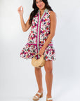 Trendy fall mini dress in plum floral print with sleeveless design and striped trim. Ideal for pre-fall outfits and everyday wear.