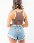 Back view of In Your Dreams Brown Cropped Tank Top showing racerback design and cream trim, paired with cuffed high-rise denim shorts.
