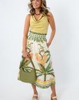 Tropical print midi skirt with palm and bird pattern, scalloped waistband, and side pockets