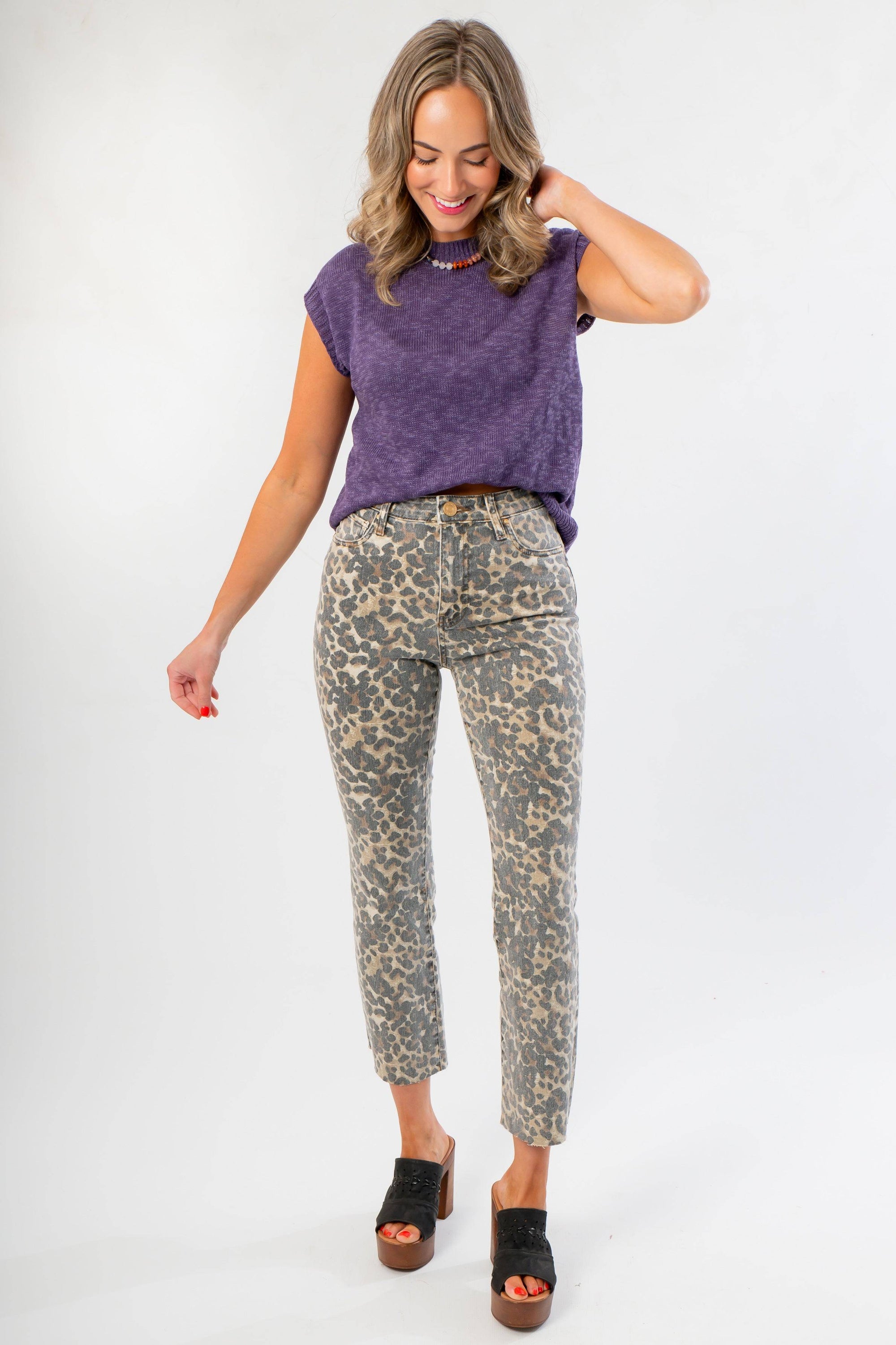 Front view of Tiffany Sleeveless Purple Ribbed Knit Top paired with animal print pants, ideal for warm fall days and gameday outfits.
