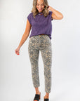 Front view of Tiffany Sleeveless Purple Ribbed Knit Top paired with animal print pants, ideal for warm fall days and gameday outfits.