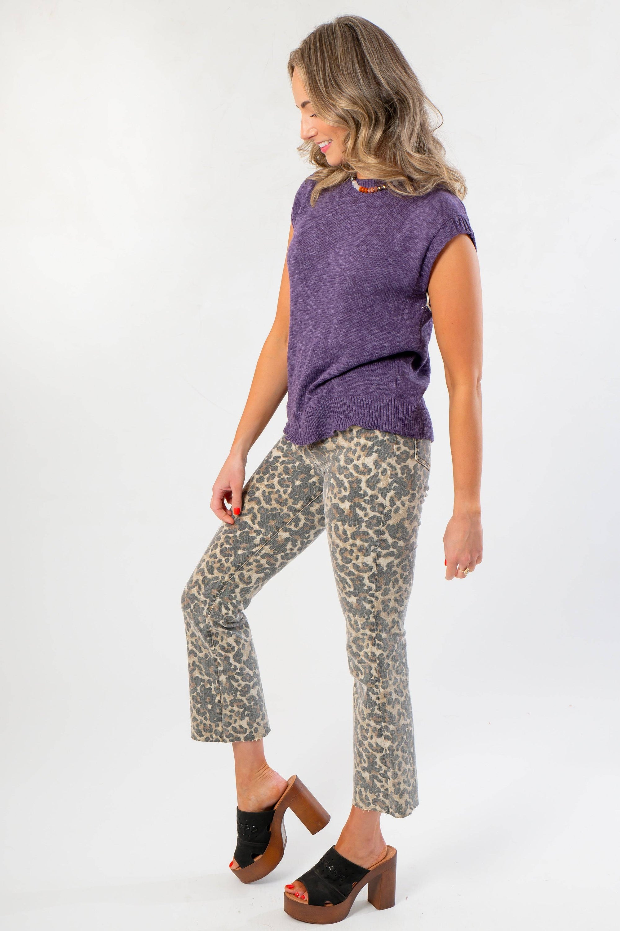 Side angle of Tiffany Sleeveless Purple Ribbed Knit Top showing relaxed fit and ribbed hem, styled for casual fall fashion.