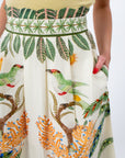 Close-up of tropical print midi skirt with palm trees and bird illustrations, high waist