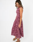 Side view of THML Tini Pink Polka Dot Midi Dress featuring a flattering A-line silhouette and lightweight fabric for summer comfort.
