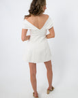 White off-shoulder mini dress with draped neckline for party wear