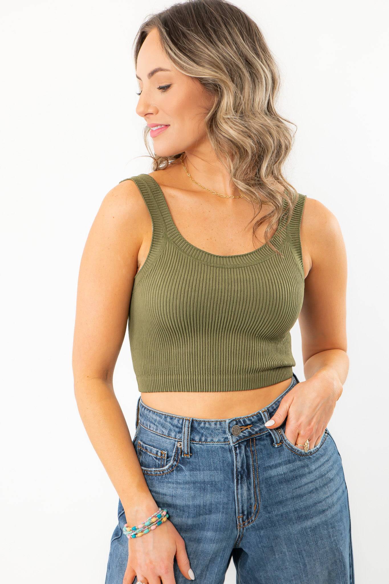 Olive Seamless Cropped Brami - A Summer Essential, featuring a ribbed texture and scoop neckline, styled with high-waisted denim jeans.