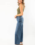 Olive Seamless Cropped Brami styled with high-waisted wide-leg jeans, showcasing a summer essential activewear top in a ribbed olive green fabric.