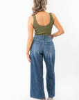 Back view of Olive Seamless Cropped Brami, a ribbed olive green activewear top paired with high-waisted wide-leg jeans. A summer essential for layering.