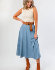 Washed Denim Paneled Midi Skirt styled with a sleeveless knit top and brown belt, perfect for fall fashion with boots.