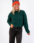 Tree Farm Stroll Cable-Knit Sweater in forest green with chunky knit texture and relaxed fit, styled with black jeans for a cozy holiday look.