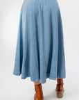 Back view of Washed Denim Paneled Midi Skirt highlighting the flared hem and structured panel seams for a graceful drape.