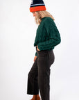Side view of Tree Farm Stroll Cable-Knit Sweater showcasing its thick cable-knit design and cropped hem, ideal for winter layering.