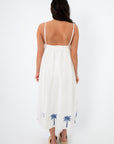 Back view of MINKPINK Isadora Palm Embroidered Midi Dress with open back and elastic waist, ideal for a chic summer vacation look.