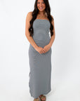 Model wearing strapless navy stripe maxi dress for summer vacation