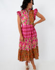Side view of vibrant patchwork midi dress with floral and geometric prints