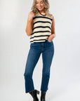 Trendy and comfortable On The Daily Dark Wash Crop Flare Jeans paired with a striped knit top, ideal for pre-fall fashion.
