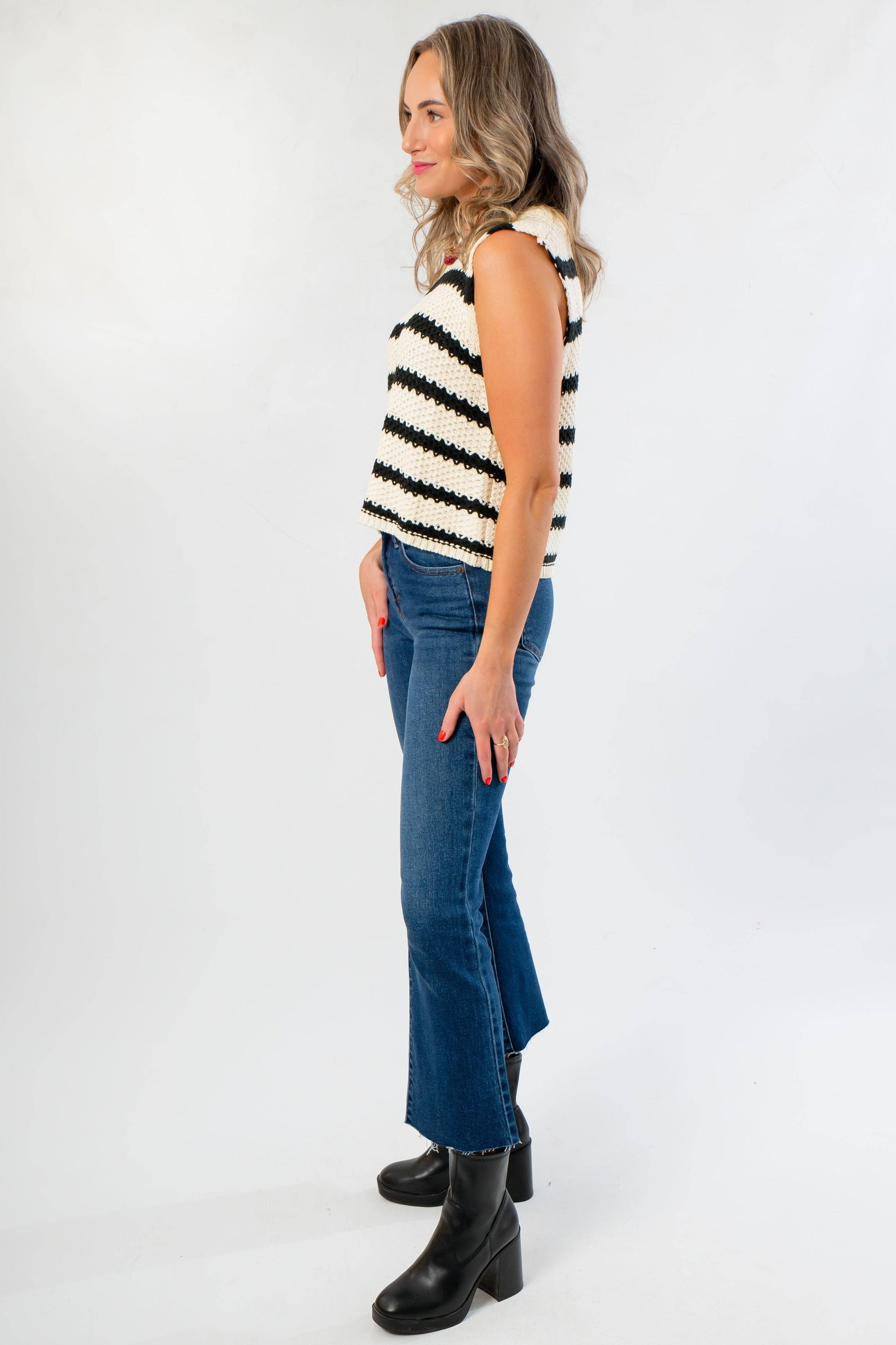 Side profile of On The Daily Dark Wash Crop Flare Jeans featuring a high-rise fit and raw hem, perfect for stylish everyday wear.