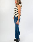 Side profile of On The Daily Dark Wash Crop Flare Jeans featuring a high-rise fit and raw hem, perfect for stylish everyday wear.