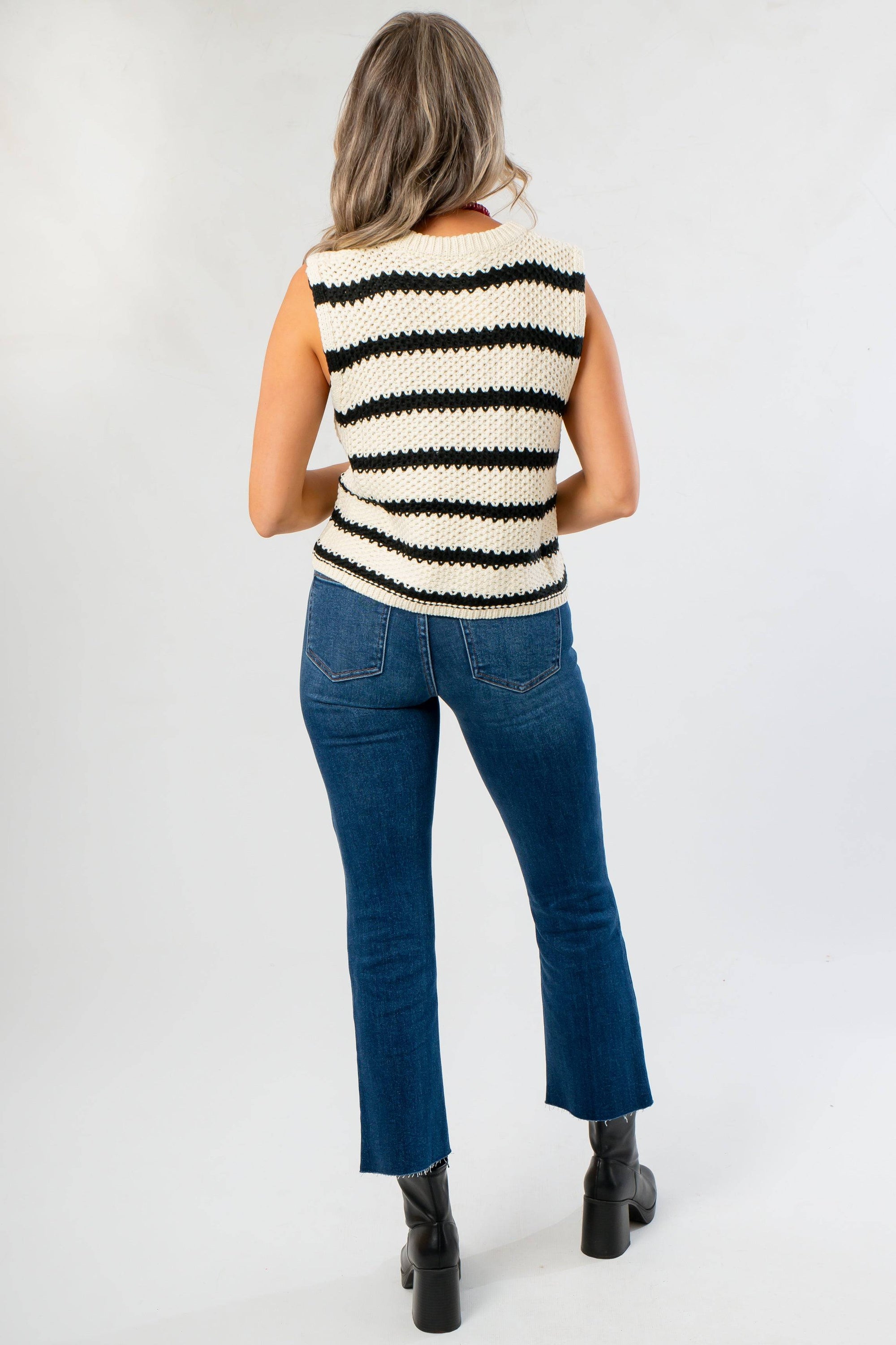 Back view of Oreo Striped Sleeveless Sweater featuring horizontal black and white stripes, styled for casual fall fashion.