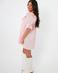 Side view of Show Me Your Mumu Pink Eyelet Toulouse Dress showing puff sleeves and relaxed fit, ideal for warm-weather casual wear.