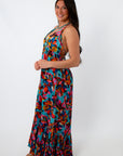 Colorful tropical floral halter maxi dress on smiling woman