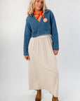 Versatile Denim Long Sleeve Top with front pockets, paired with neutral skirt and boots. Ideal for layering in transitional weather.