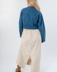 Back view of Denim Long Sleeve Top - Wide Open Layering paired with flowy cream skirt. Lightweight and stylish for fall layering.