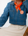 Close-up of Wide Open Denim Long Sleeve Top showing front pockets and collar detail. Lightweight denim perfect for gameday or casual wear.