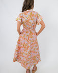 Back view of Coral Gables Floral Midi Shirt Dress showing elastic waist and soft pleats, ideal for casual or resort wear.