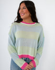 Women’s Cabana Stripe Lightweight Sweater featuring pastel mint and sky blue stripes with pink accents, paired with high-rise jeans. Soft spring knit top.