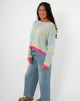 Cabana Stripe Lightweight Sweater styled with wide-leg denim and sandals, showcasing relaxed fit and pastel color blocking. Perfect for spring layering.