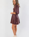 Side view of Bordeaux Bliss Faux Leather Dress showing structured fit, puff sleeves, and smooth faux leather texture in wine red.