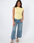 Friday Feeling Butter Yellow Asymmetrical Knit Top styled with wide-leg jeans and platform sandals. Lightweight spring knit tank top for women.