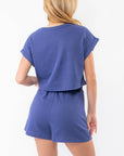 Back view of Keeping Tabs Blue Crop Tee highlighting cropped hem and relaxed fit, a versatile blue crop top T-shirt for everyday wear.