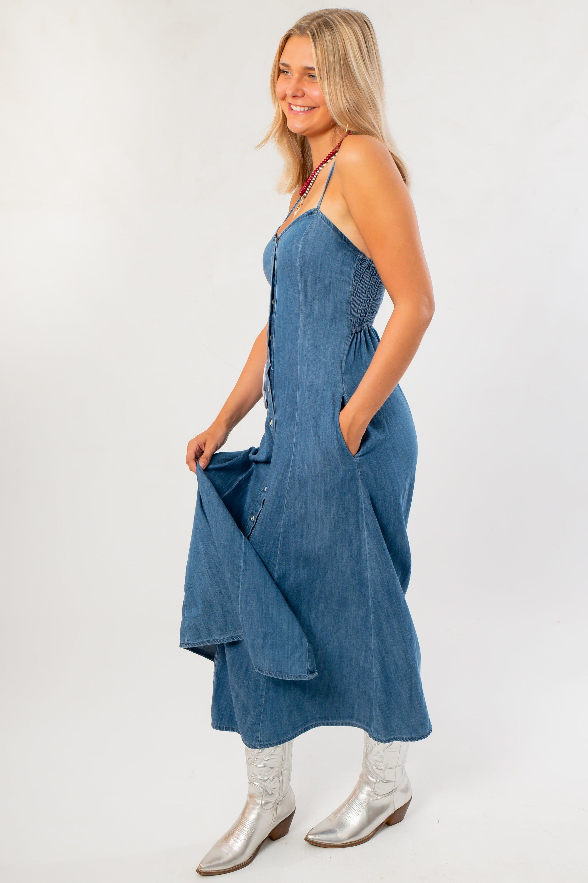 Side view of Z Supply Indigo Angel Eyes Denim Midi Dress showing adjustable straps, side pockets, and lightweight denim fabric.