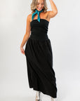 Versatile black strapless midi dress in natural linen, perfect for fall or gameday, paired with silver boots and teal scarf for a trendy outfit.