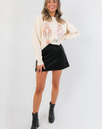 Women's Z Supply Black Ciera Suede Mini Skirt paired with festive sweater and boots, ideal for holiday and gameday fashion.